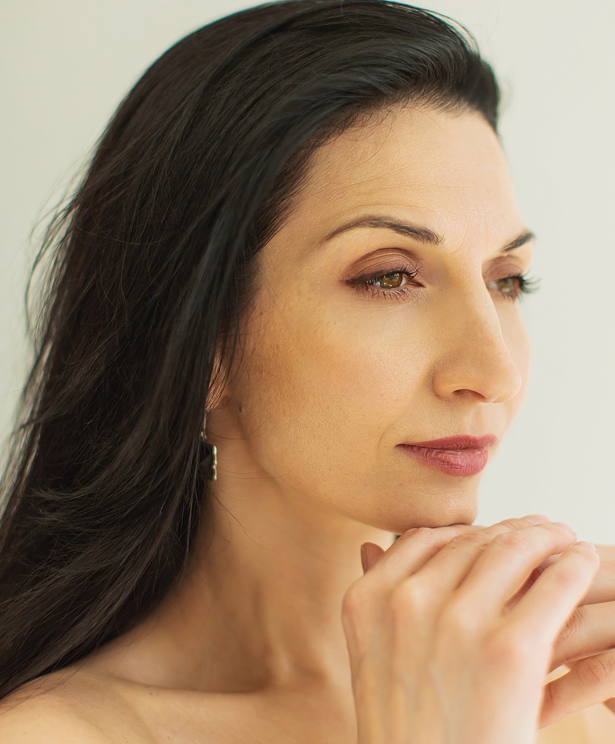 Portrait of a thoughtful woman with long hair.