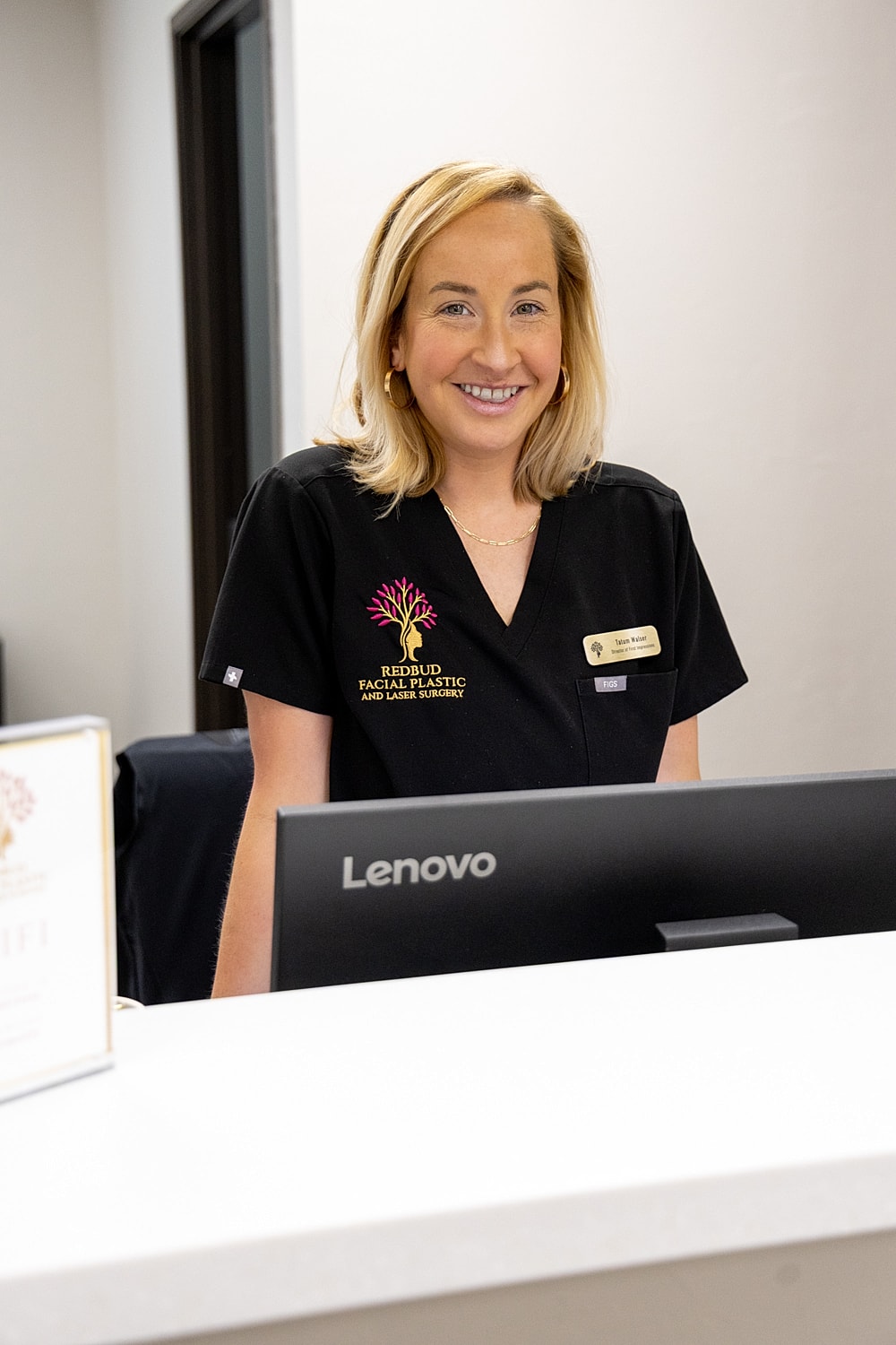 Smiling receptionist at a medical office.