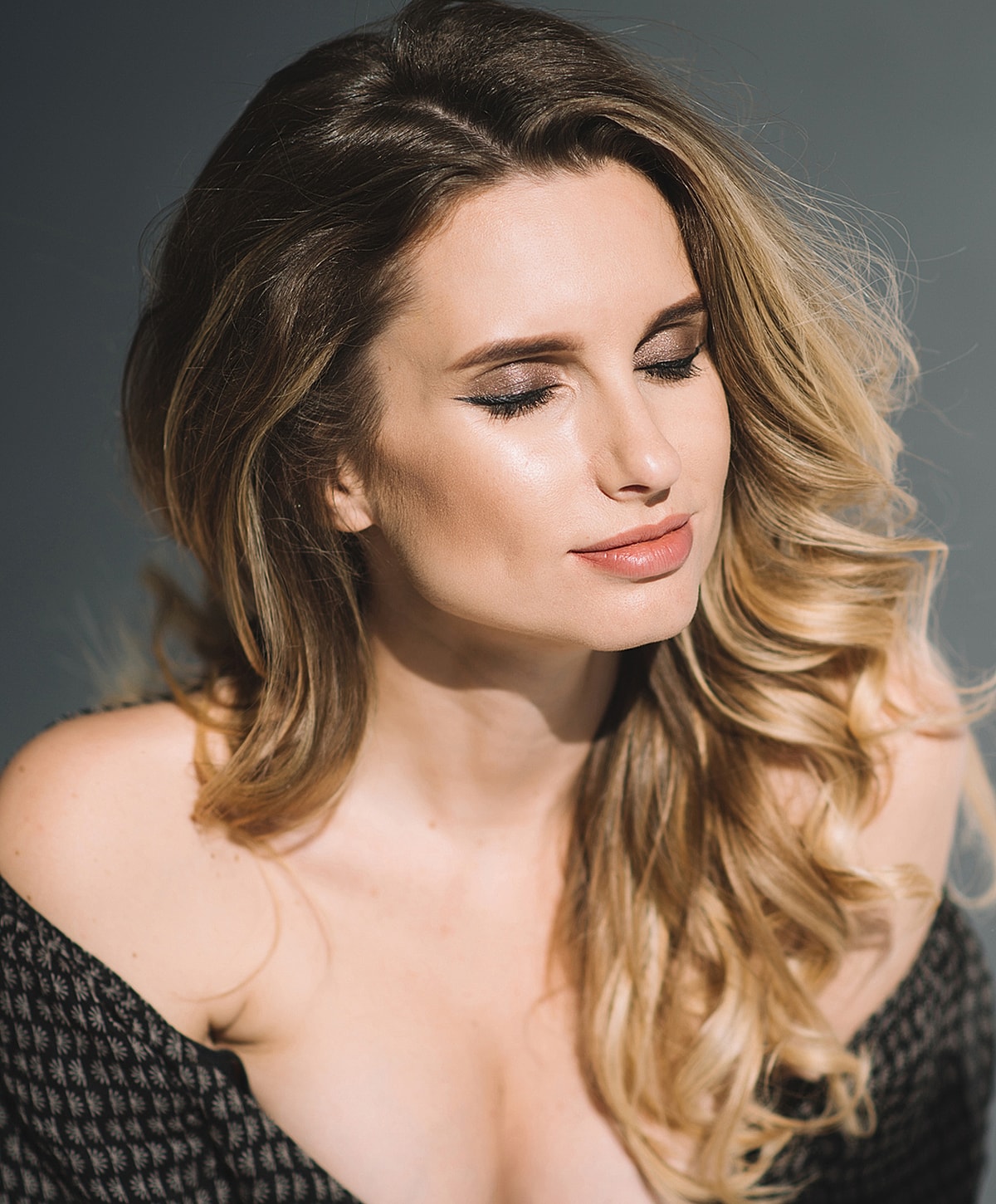 Woman with closed eyes and flowing hair.