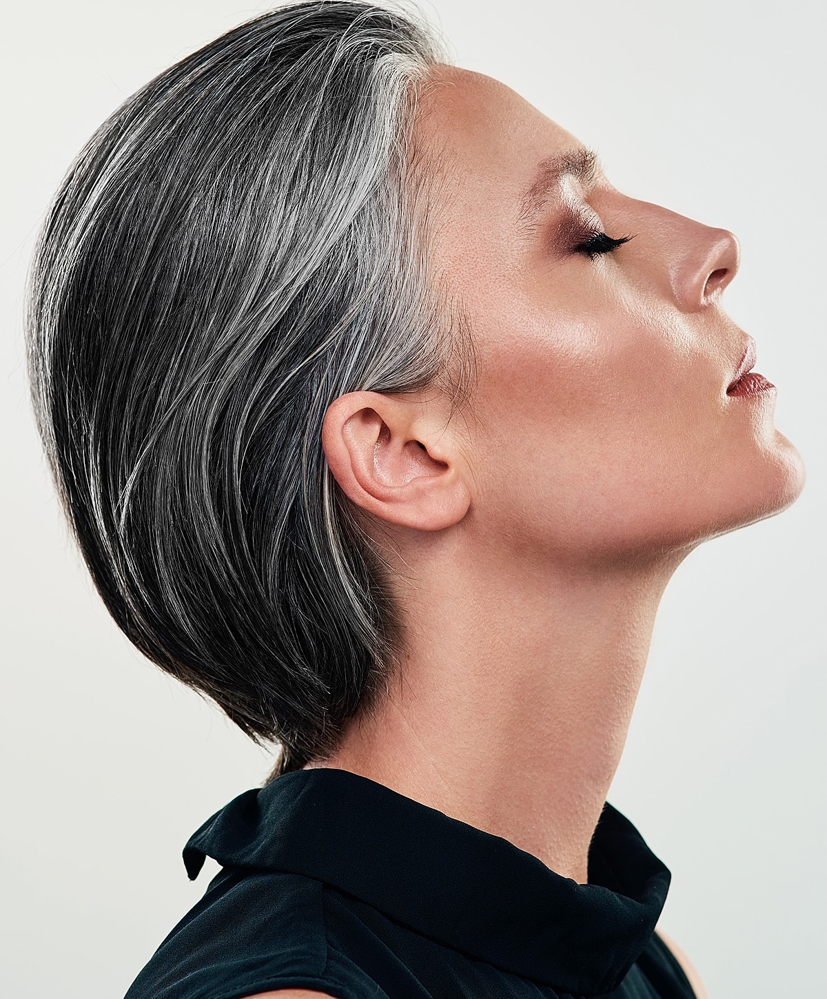 Profile of a woman with silver hair.