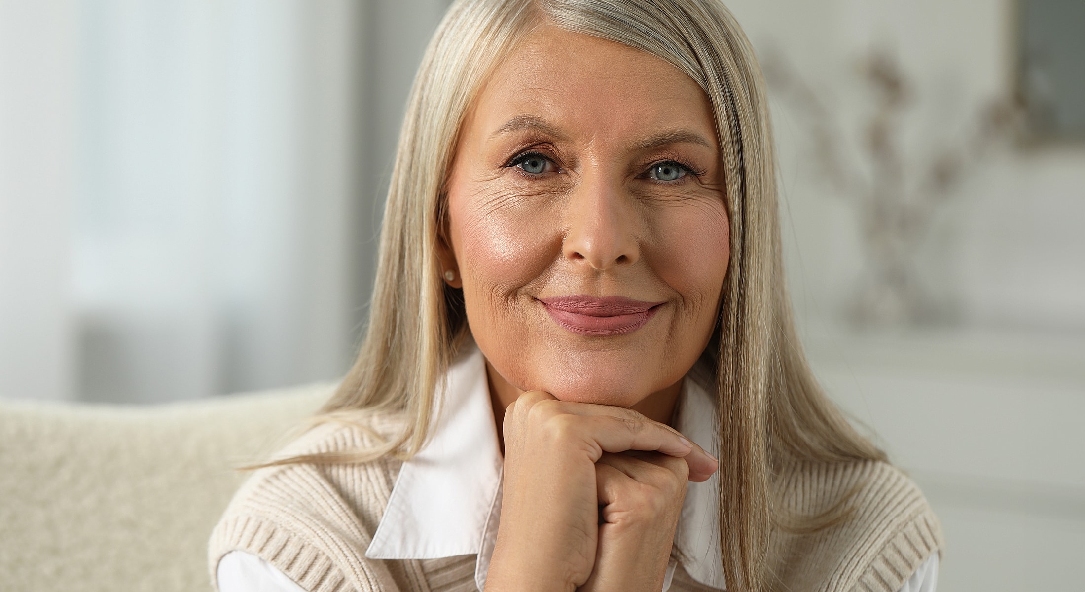 Smiling older woman with long, straight hair.
