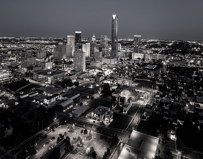 City skyline illuminated at night in monochrome.