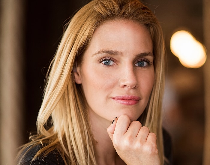 Woman with blonde hair and blue eyes.