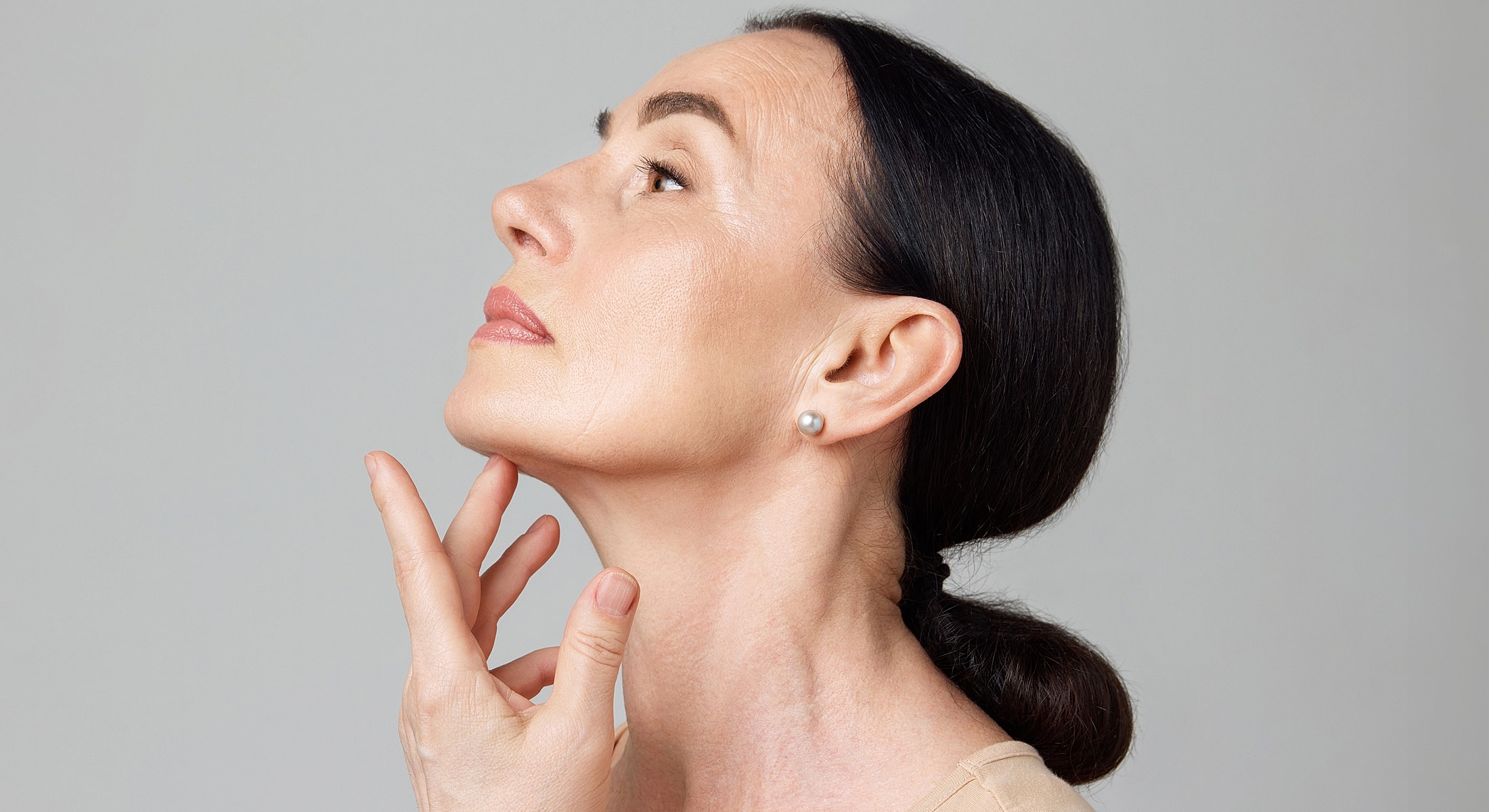 Profile of a woman touching her chin thoughtfully.