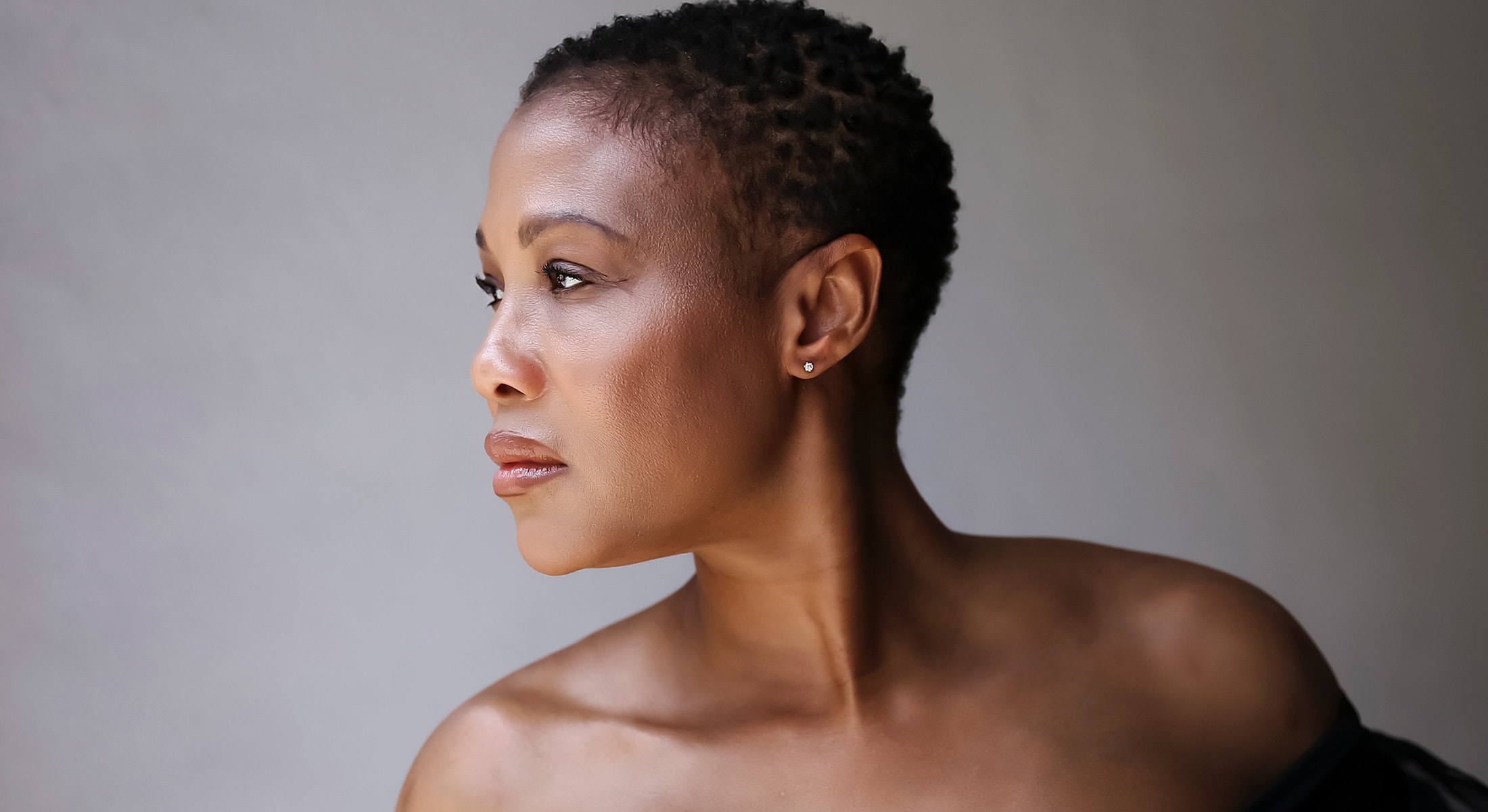 Profile portrait of a woman with short hair.